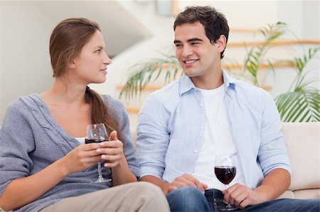 Couple having a glass of red wine while looking at each other Stock Photo - Budget Royalty-Free & Subscription, Code: 400-05739960