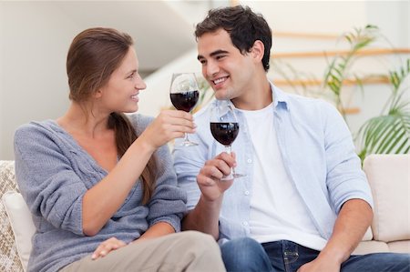 Couple having a glass of wine in their living room Stock Photo - Budget Royalty-Free & Subscription, Code: 400-05739961