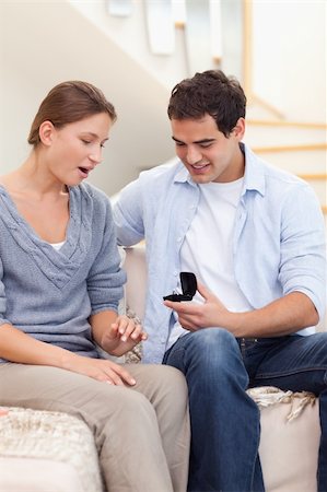 Portrait of a man offering a ring to her girlfriend in their living room Stock Photo - Budget Royalty-Free & Subscription, Code: 400-05739994