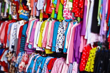 Colorful baby clothes hanging on hangers in a store Photographie de stock - Aubaine LD & Abonnement, Code: 400-05730381