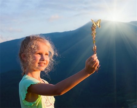 Small  caucasian girl in last mountain sunset light admire on yellow Swallowtail butterfly Stock Photo - Budget Royalty-Free & Subscription, Code: 400-05730614