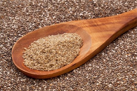 simsearch:400-06556120,k - a wooden spoon of  organic ground chia seeds against the whole seeds background Fotografie stock - Microstock e Abbonamento, Codice: 400-05731042