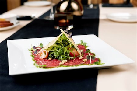 eating olive - Beef carpaccio with salad and Parmesan cheese Stock Photo - Budget Royalty-Free & Subscription, Code: 400-05731277