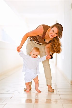 simsearch:400-06086432,k - Happy mom helping baby to walk Stockbilder - Microstock & Abonnement, Bildnummer: 400-05731506