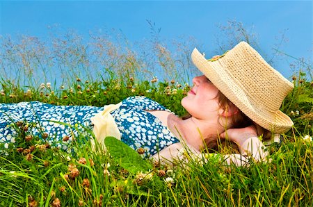 Young teenage girl resting on summer meadow in straw hat Stock Photo - Budget Royalty-Free & Subscription, Code: 400-05731714