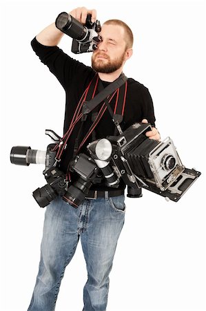 Photo of a man in his late twenties, standing and holding many cameras, film, digital, medium format and large format. Stock Photo - Budget Royalty-Free & Subscription, Code: 400-05732098
