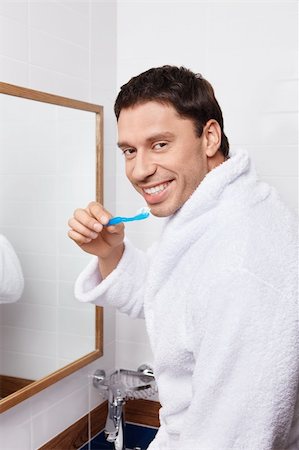 A young man brushing his teeth in the bathroom Stock Photo - Budget Royalty-Free & Subscription, Code: 400-05732849