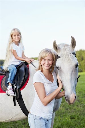 Mother and daughter with a horse Stock Photo - Budget Royalty-Free & Subscription, Code: 400-05732868