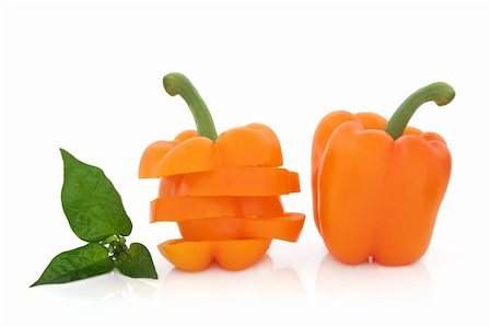 simsearch:400-06061963,k - Orange pepper vegetable sliced and whole with leaf spring isolated over white background. Foto de stock - Royalty-Free Super Valor e Assinatura, Número: 400-05733669