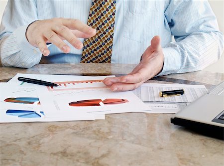 revenue - Closeup of male hands over financial  charts Stock Photo - Budget Royalty-Free & Subscription, Code: 400-05744999