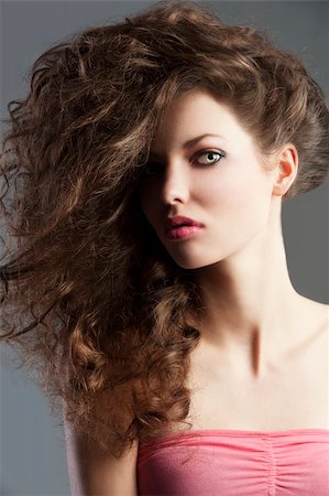 simsearch:400-05744994,k - beauty fashion portrait of beautiful young brunette with curly hair flying and creative hairstyle, she looks in to the lens and her face is turned of three-quarters. Stock Photo - Budget Royalty-Free & Subscription, Code: 400-05744992