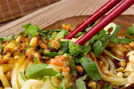 simsearch:633-01274958,k - Close-up photograph of red chopsticks on freshly prepared Asian noodles. Photographie de stock - Aubaine LD & Abonnement, Code: 400-05745083