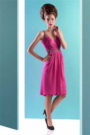 simsearch:400-05744994,k - fashion shot of an elegant young woman posing on turquoise background wearing a pink evening dress and a fashion up-do Stock Photo - Budget Royalty-Free & Subscription, Code: 400-05745326