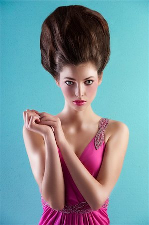 simsearch:400-06102733,k - very elegant young pretty wearing a pink long dress with creative hair style over light turquoise background Fotografie stock - Microstock e Abbonamento, Codice: 400-05745320