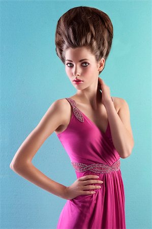 simsearch:400-06102733,k - very elegant young woman wearing a pink evening dress and fashion up-do on turquoise background Fotografie stock - Microstock e Abbonamento, Codice: 400-05745323