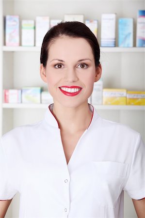 Pretty caucasian smiling pharmacist wearing white uniform. Stock Photo - Budget Royalty-Free & Subscription, Code: 400-05745337