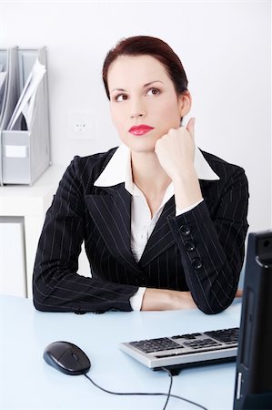 simsearch:400-05729276,k - Portrait of a beautiful business woman sitting behind the desk trying to work out a solution for the problem. Stock Photo - Budget Royalty-Free & Subscription, Code: 400-05745332