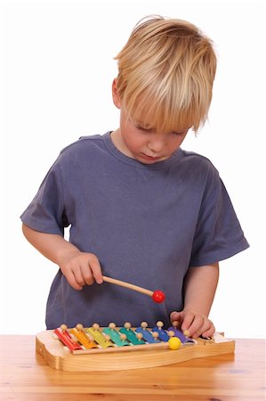 Portrait of a young boy playing a toy xylophone Fotografie stock - Microstock e Abbonamento, Codice: 400-05745960