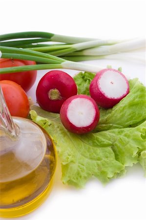Radish on salad leaves, oil and onion on white Stock Photo - Budget Royalty-Free & Subscription, Code: 400-05745996