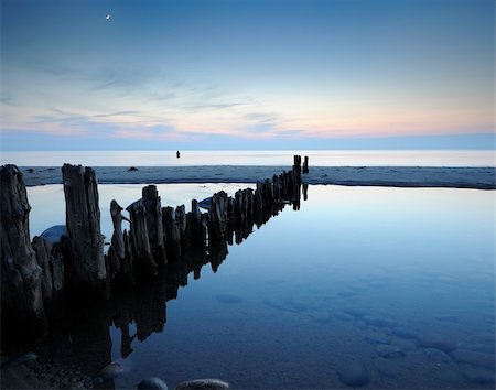 simsearch:400-05369767,k - breakwater late one evening with a man fishing in the water and the moon up Stock Photo - Budget Royalty-Free & Subscription, Code: 400-05746141