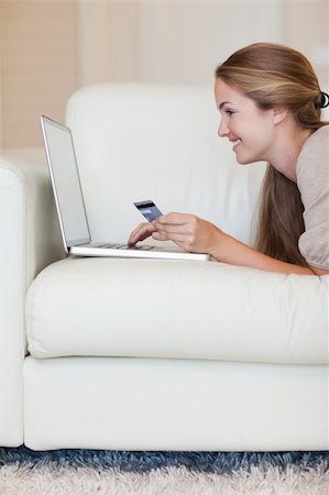 simsearch:400-05742016,k - Portrait of a young woman shopping online in her living room Stock Photo - Budget Royalty-Free & Subscription, Code: 400-05746669