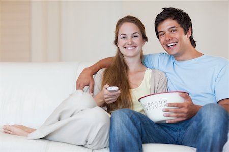 simsearch:400-05748052,k - Couple watching television while eating popcorn in their living room Foto de stock - Super Valor sin royalties y Suscripción, Código: 400-05746670