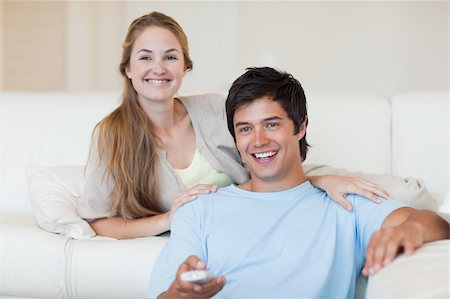 simsearch:400-05748048,k - Young couple watching television in their living room Stockbilder - Microstock & Abonnement, Bildnummer: 400-05746687