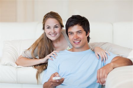 simsearch:400-05748048,k - Happy couple watching television in their living room Stockbilder - Microstock & Abonnement, Bildnummer: 400-05746688