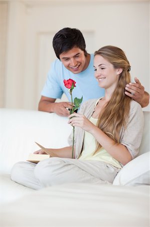 simsearch:400-04655735,k - Portrait of a man offering a rose to his fiance in their living room Stockbilder - Microstock & Abonnement, Bildnummer: 400-05746683