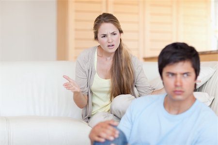 simsearch:400-06172922,k - Upset young couple arguing in their living room Stock Photo - Budget Royalty-Free & Subscription, Code: 400-05746711
