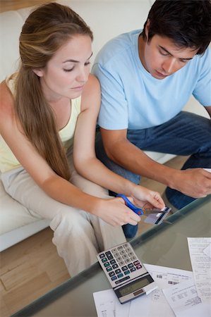 Portrait of a sad young couple looking at their bills in their living room Stock Photo - Budget Royalty-Free & Subscription, Code: 400-05746765