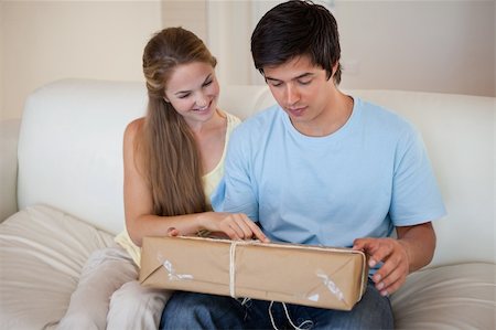 Couple looking at a package in their living room Stock Photo - Budget Royalty-Free & Subscription, Code: 400-05746778