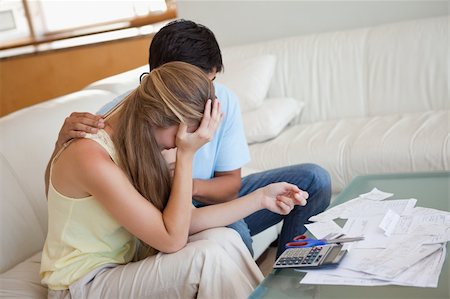 Sad couple in financial trouble in their living room Stock Photo - Budget Royalty-Free & Subscription, Code: 400-05746771