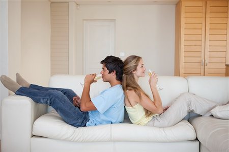 simsearch:400-04151970,k - Couple sitting back to back while drinking wine in their living room Fotografie stock - Microstock e Abbonamento, Codice: 400-05746785