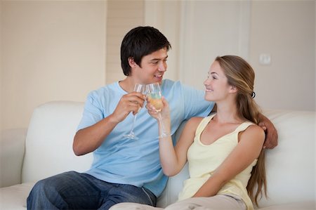 simsearch:400-04151970,k - Couple drinking a glass of sparkling wine in their living room Fotografie stock - Microstock e Abbonamento, Codice: 400-05746789