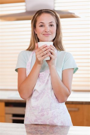 simsearch:400-04335902,k - Portrait of a woman drinking a cup of tea in her kitchen Stock Photo - Budget Royalty-Free & Subscription, Code: 400-05746897