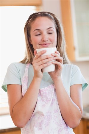 simsearch:400-04335902,k - Portrait of a quiet woman drinking a cup of tea in her kitchen Stock Photo - Budget Royalty-Free & Subscription, Code: 400-05746900