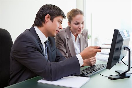simsearch:400-04918393,k - Focused business team working with a computer in an office Stock Photo - Budget Royalty-Free & Subscription, Code: 400-05746939