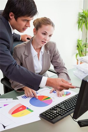 simsearch:400-04918393,k - Portrait of a serious business team studying statistics in a meeting room Stock Photo - Budget Royalty-Free & Subscription, Code: 400-05746948