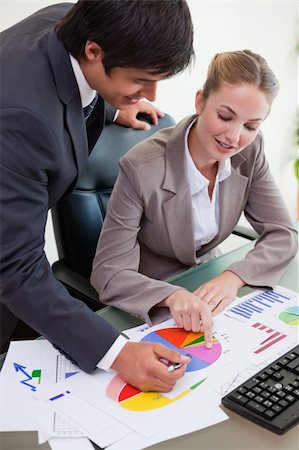 simsearch:400-04918393,k - Portrait of a business team studying statistics in a meeting room Stock Photo - Budget Royalty-Free & Subscription, Code: 400-05746940
