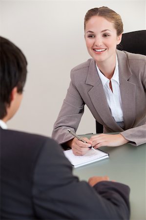 Portrait of a smiling manager interviewing a male applicant in her office Stock Photo - Budget Royalty-Free & Subscription, Code: 400-05746960
