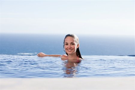 simsearch:400-04456529,k - Woman in a swimming pool smiling at the camera Stock Photo - Budget Royalty-Free & Subscription, Code: 400-05746998