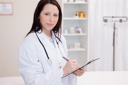 simsearch:400-04417775,k - Young female physician taking notes Foto de stock - Super Valor sin royalties y Suscripción, Código: 400-05747010