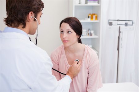 female heartbeat stethoscope - Young male doctor taking his patients heart beat Stock Photo - Budget Royalty-Free & Subscription, Code: 400-05747083