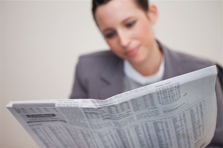 Newspaper being read by young businesswoman Stock Photo - Budget Royalty-Free & Subscription, Code: 400-05747315