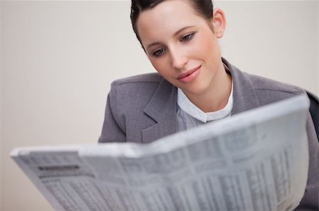 Young businesswoman reading newspaper Stock Photo - Budget Royalty-Free & Subscription, Code: 400-05747311