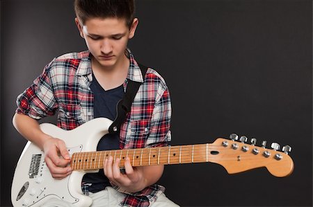 simsearch:400-04921650,k - Photo of a teenage male playing a white electric guitar. Stock Photo - Budget Royalty-Free & Subscription, Code: 400-05747580
