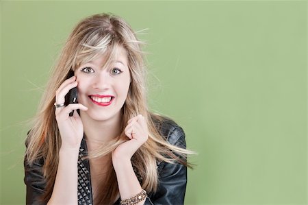 Excited Caucasian teen with phone and messy hair Stock Photo - Budget Royalty-Free & Subscription, Code: 400-05747801