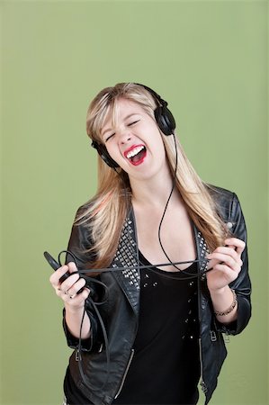 Retro-styled Caucasian teen enjoys music on headphones Stock Photo - Budget Royalty-Free & Subscription, Code: 400-05747803