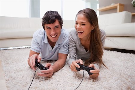 simsearch:400-05297936,k - Young couple playing video games together Stock Photo - Budget Royalty-Free & Subscription, Code: 400-05748029